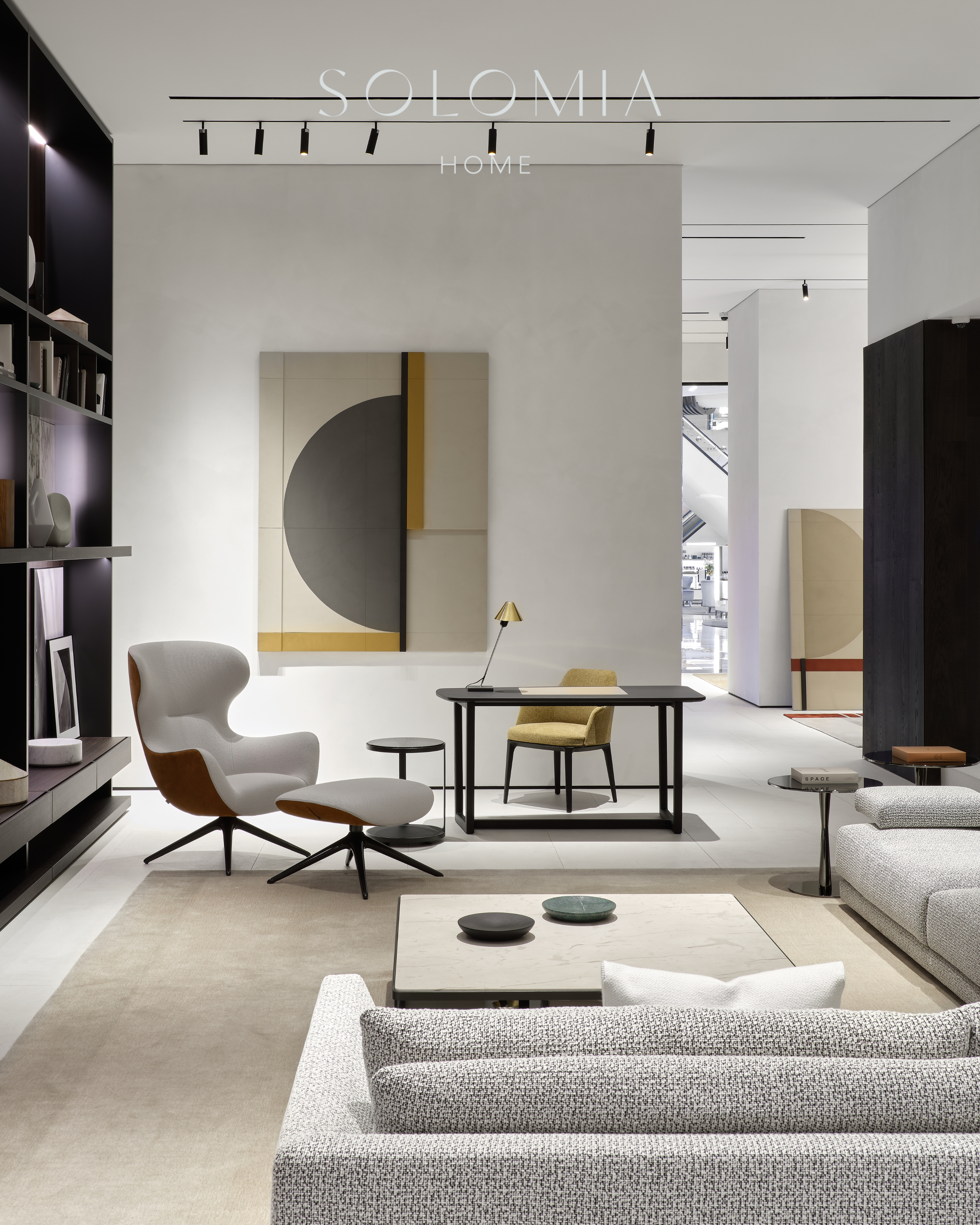 Grey armchair by a desk, Poliform Project — showroom interior design Astana