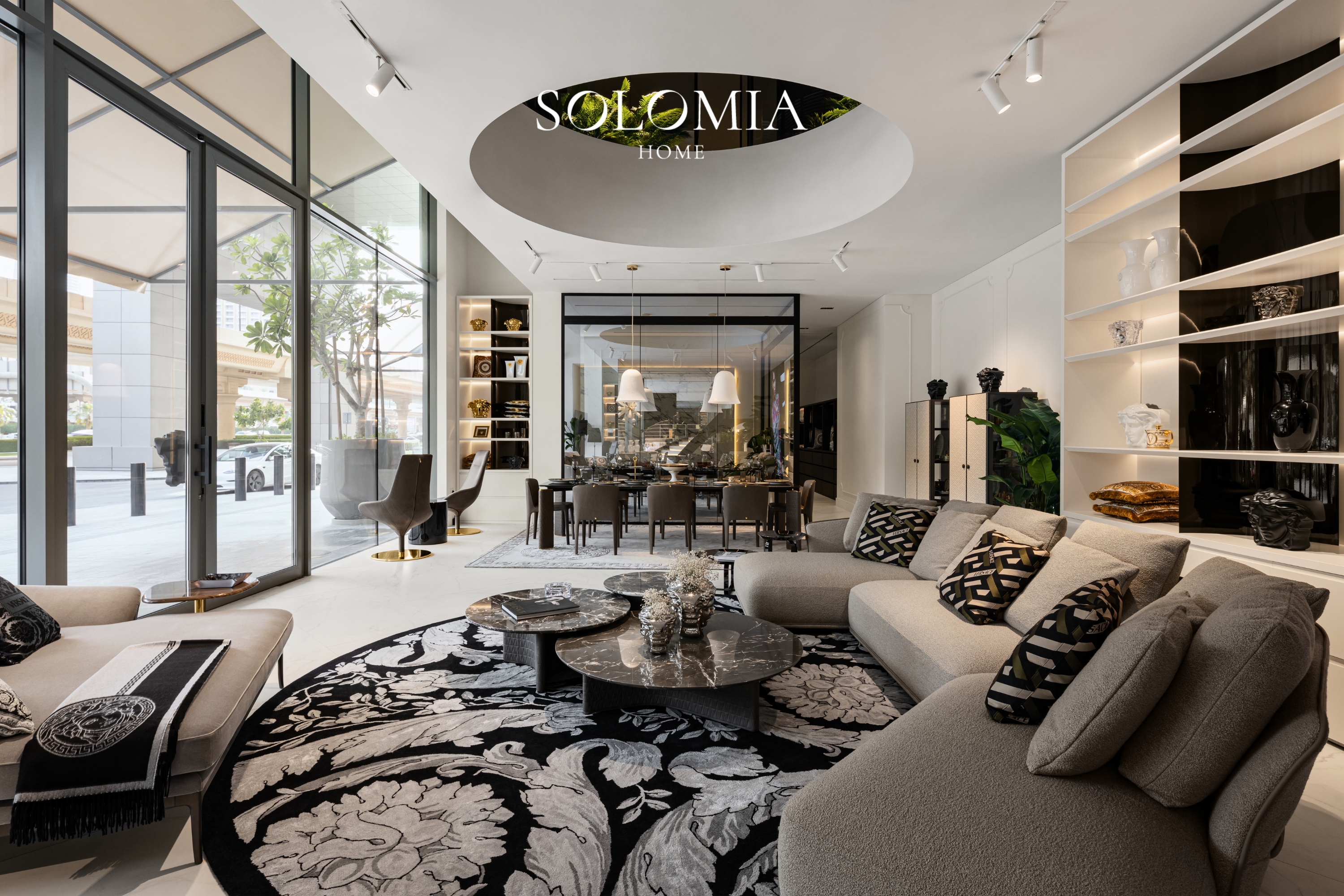 Showroom with patterned rug and dining area, Versace Home showroom Dubai Mall — commercial interior design by Solomia Design