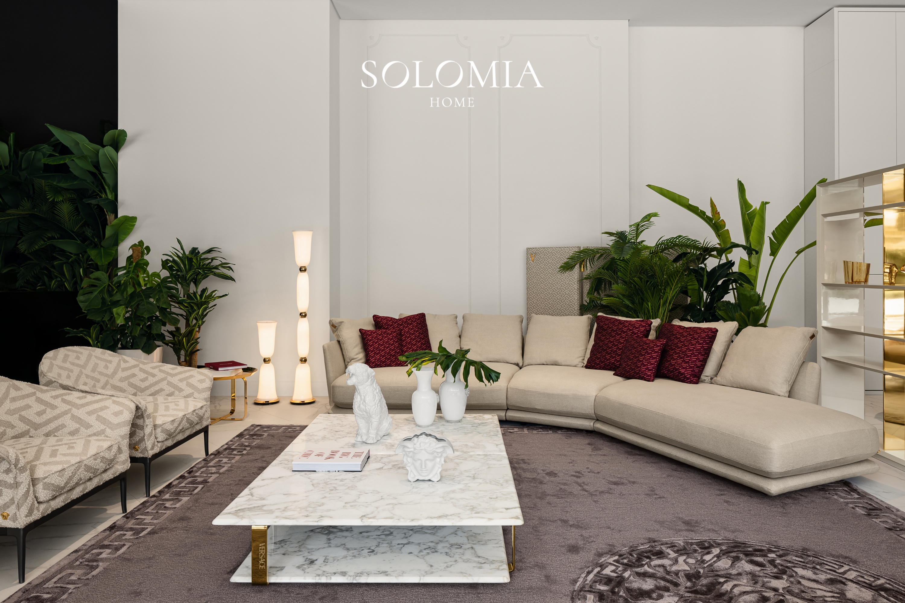 Showroom lounge with beige sofa and burgundy cushions, Versace Home showroom Dubai Mall — commercial interior design by Solomia Design