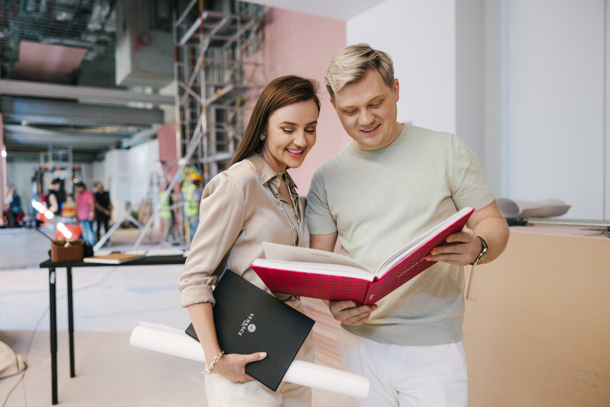 Solomia Design designers reviewing a project book on site — interior design company in Dubai